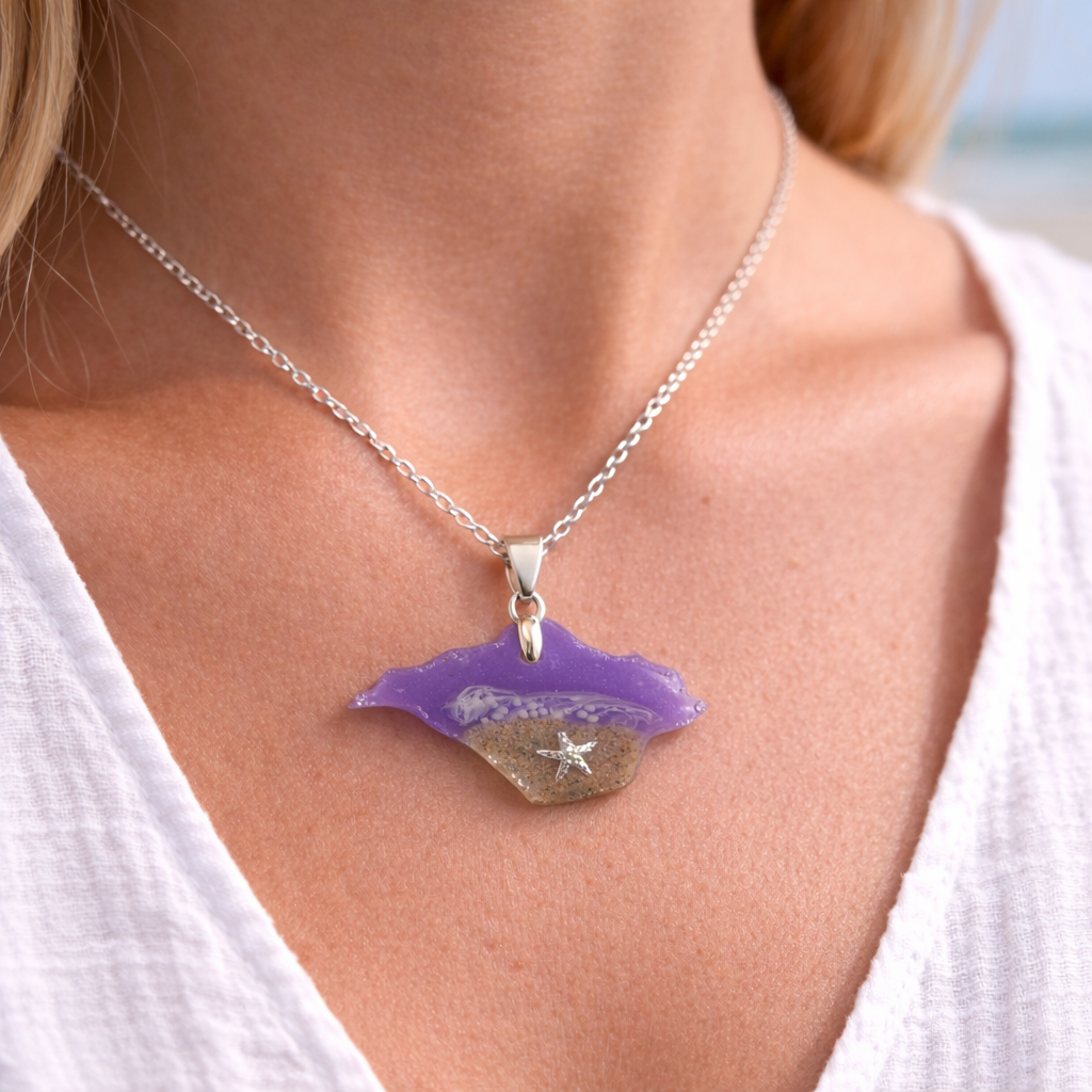 Model wearing a purple Isle of Wight resin necklace with real beach sand and starfish charm on silver chain