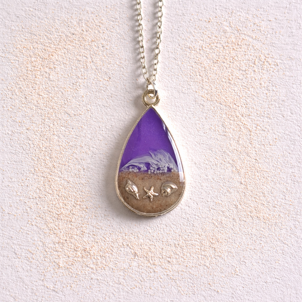 Purple resin teardrop necklace with Isle of Wight sand and shell charms on silver chain