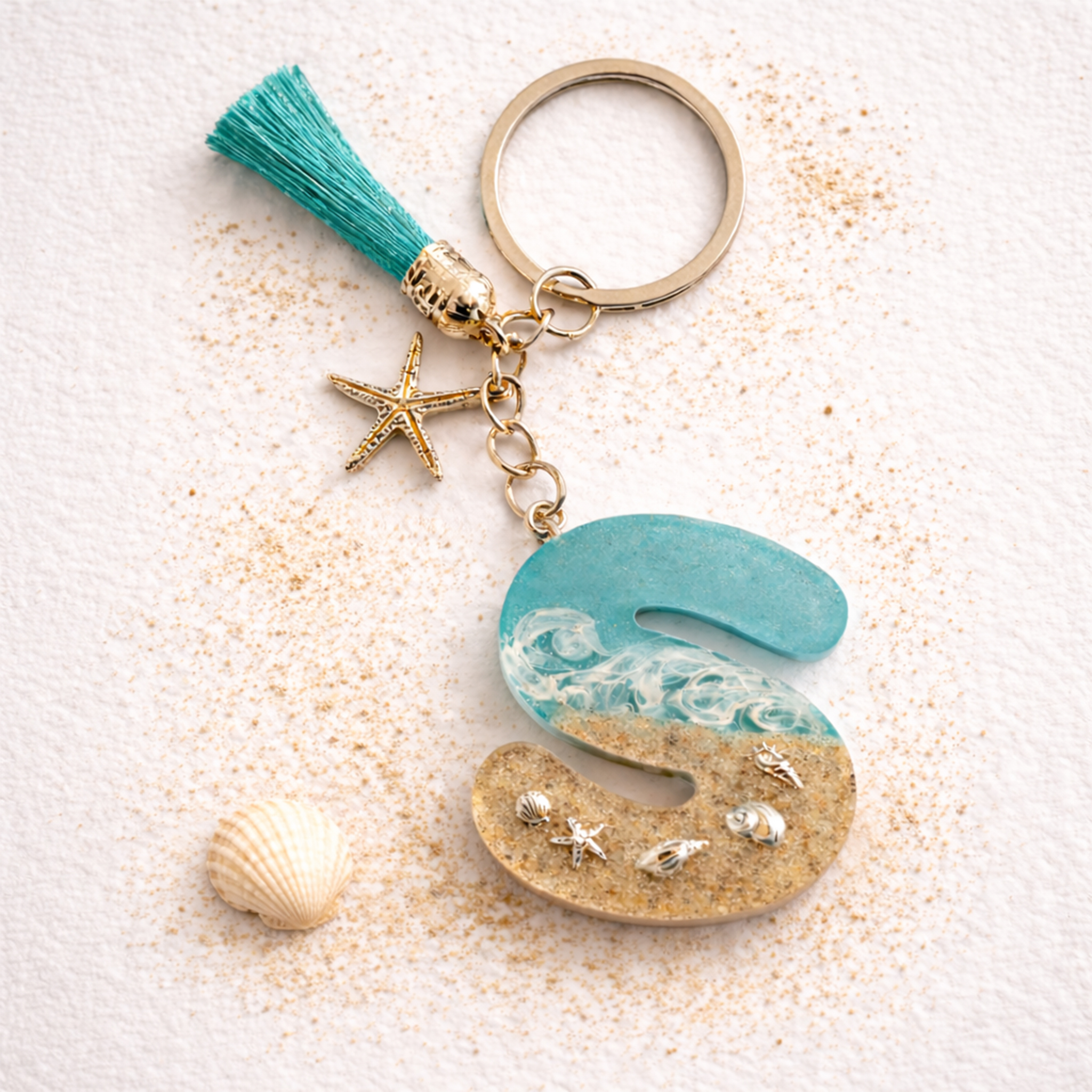 Isle of Wight letter S resin keyring with sand, wave design and starfish charm on neutral background