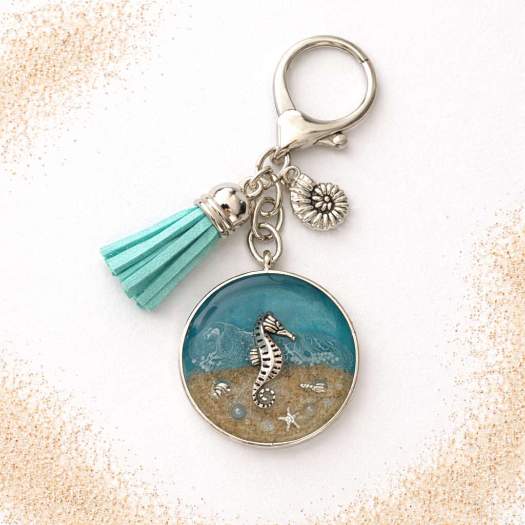 Isle of Wight resin keyring with real beach sand, seahorse charm, seahorse and turquoise tassel.