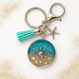 Isle of Wight resin keyring with real beach sand, starfish charm, and turquoise tassel.