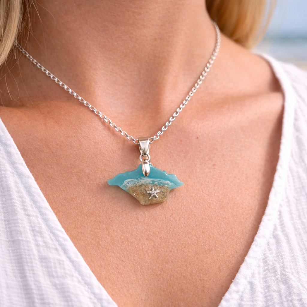Model wearing a turquoise Isle of Wight resin necklace with real beach sand and starfish charm on silver chain