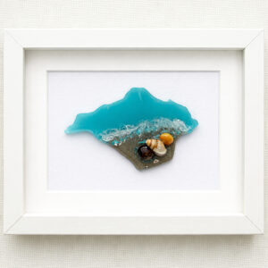 Framed Isle of Wight resin artwork featuring turquoise sea, real sand and shells on a linen background