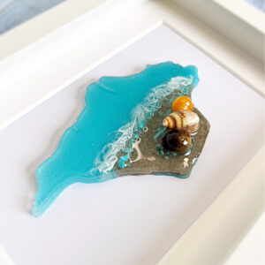 Framed Isle of Wight resin artwork featuring turquoise sea, real sand and shells on a linen background