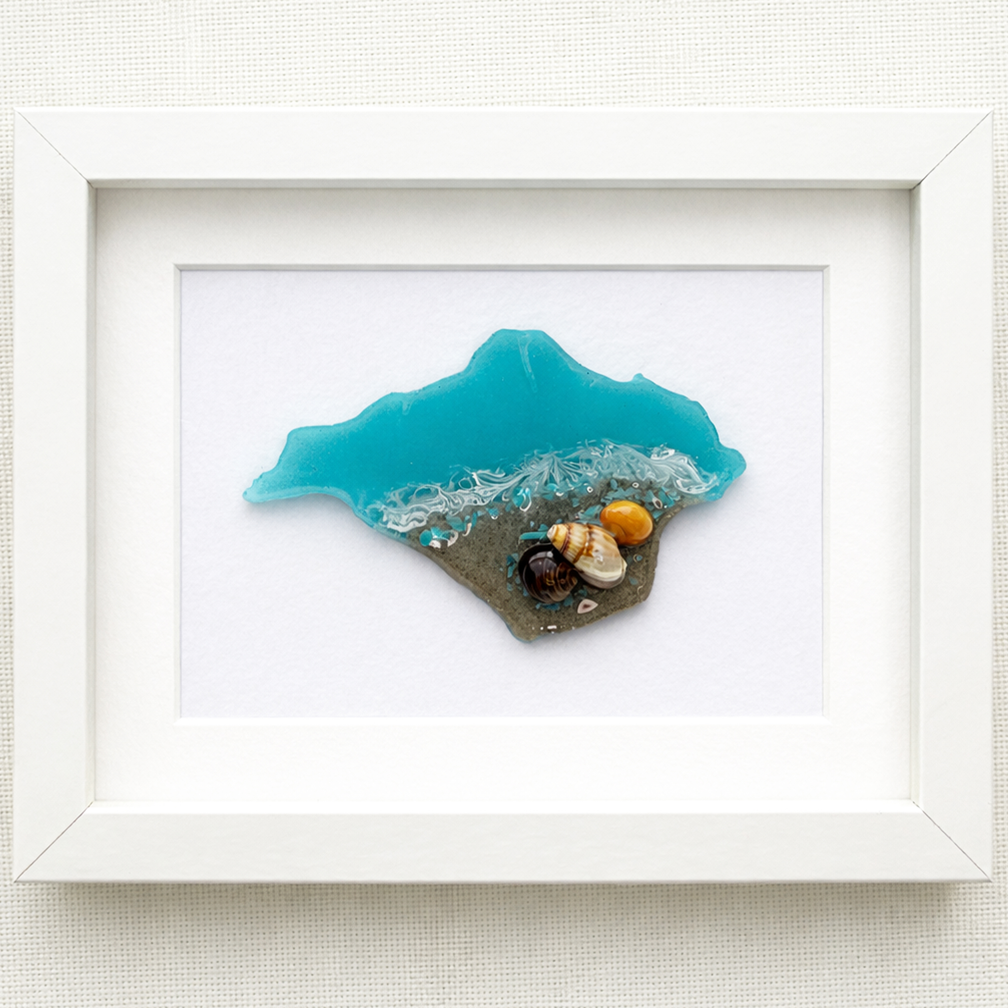 Framed Isle of Wight resin artwork featuring turquoise sea, real sand and shells on a linen background