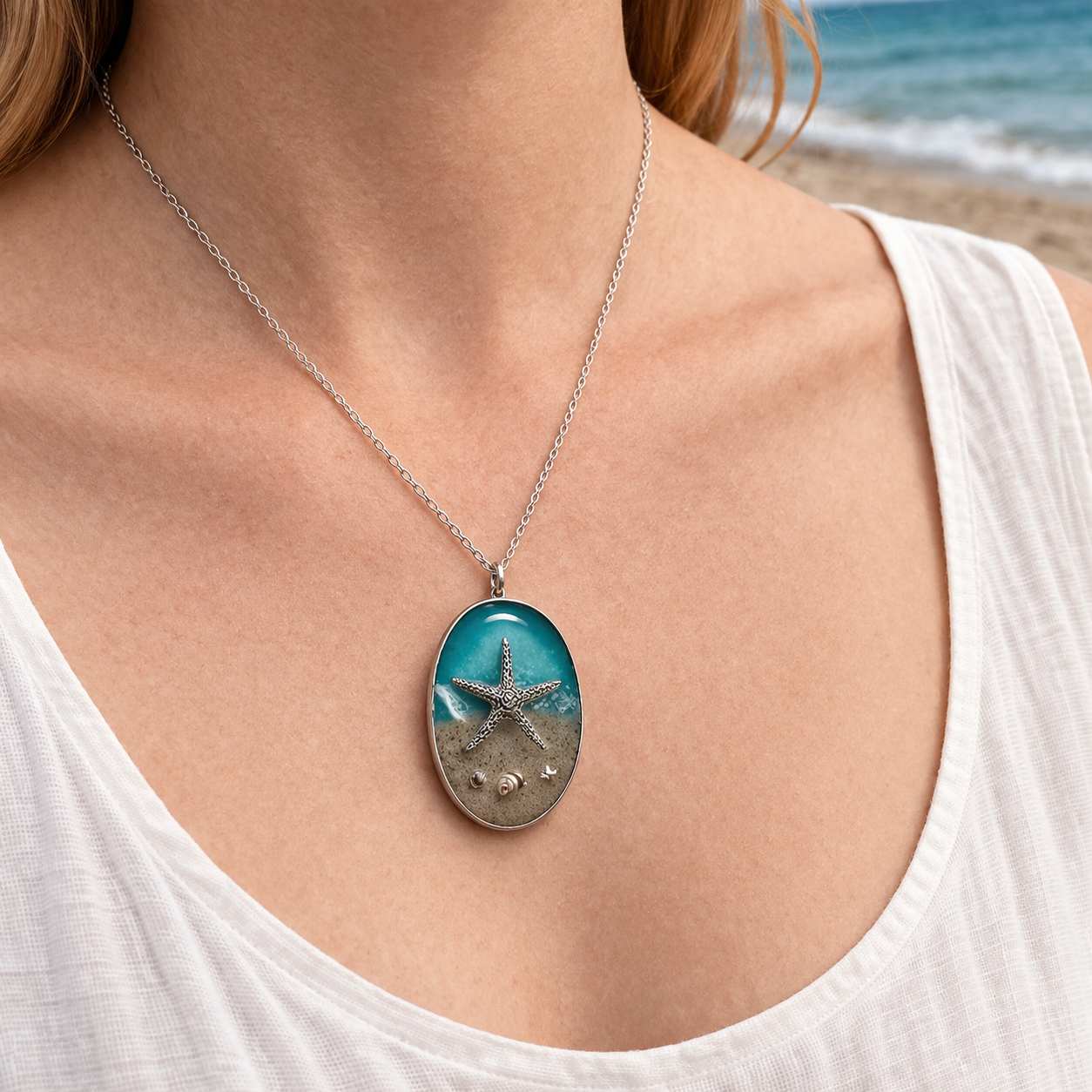 Starfish pendant necklace worn on the beach showing scale and style on a stainless steel chain