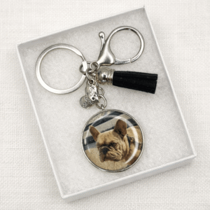 Personalised photo keyring with custom dog or cat image in a silver pendant, featuring a tassel and charm, displayed in a gift box