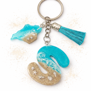 Isle of Wight letter S resin keyring with sand, wave design and starfish charm on neutral background