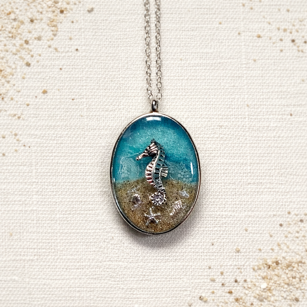 Isle of Wight seahorse pendant necklace with resin, sand and silver charm on a linen background